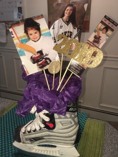 a pair of sneakers and some cake toppers on a table in front of a photo