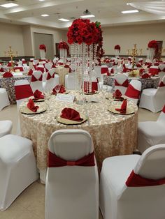 a banquet room set up with white and red linens