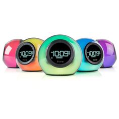 three alarm clocks with different colors on each one and the same time displayed in front of them