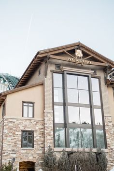 the front of a building with large windows