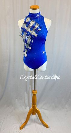 a mannequin wearing a blue top with silver sequins and stars on it