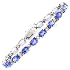 Very Impressive 22.60 Carats Natural Tanzanite & Diamond 14K Solid White Gold Bracelet Suggested Replacement Value: $9,000.00 STAMPED: 14K Total Natural Round Diamonds Weight: Approx. 0.60 Carats (color G-H / Clarity SI1-SI2) Total Natural Tanzanites Weight is: Approx. 22.00 carats Tanzanites Measure: 8.00 x 6.00mm Bracelet length is: 7 inches Bracelet Width: 6mm Bracelet total weight: Approx. 11.8g Disclaimer: all weights, measurements and colors are approximate and may vary slightly from the l White Gold Diamond Bracelet, Bracelet Tennis, Tanzanite Diamond, Gold Armband, Bracelets Gold Diamond, White Gold Bracelet, Natural Tanzanite, Yellow Gold Bracelet, Tennis Bracelet Diamond