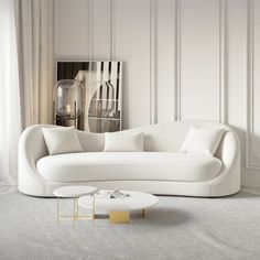 a white couch and table in a room with white paneling on the wall behind it