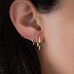 Beautifully crafted, emerald hoop earrings. They look so luxurious! The pavé diamond details and set against an emerald stone make this a unique hoop earring! - - - D E T A I L S - - -  * Hypoallergenic - great for sensitive ears! * Nickel-free * Made of 925 Sterling Silver  * THICK plating of 14k Gold or Rhodium  * 12.5mm Diameter * Lab Created emerald cz stone - we use the highest quality for an authentic look! EARRINGS ON MODEL: Emerald Huggies --> https://www.etsy.com/listing/732451873/baguette-emerald-huggies-earrings-gold?click_key=f48332af3425033d9cee99464f8e3c97a3dca94d%3A732451873&click_sum=0f1ad8f5&ga_search_query=emerald%2Bhuggies&ref=shop_items_search_3&pro=1 2mm Ball Studs --> https://www.etsy.com/listing/1154500077/tiny-ball-stud-earrings-ball-studs-stud?click_key=4c3e5110772 Emerald Hoop Earrings, Unique Hoop Earrings, Earrings Emerald, Lab Created Emerald, May Birthstone, Nose Rings, Emerald Earrings, Emerald Stone, Pretty Rings