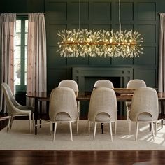 a dining room table with chairs and a chandelier