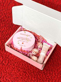 an open pink box with various items inside