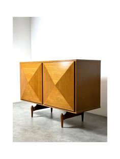 the sideboard is made out of wood and has geometric designs on it's sides