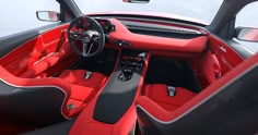 the interior of a sports car with red and black leather