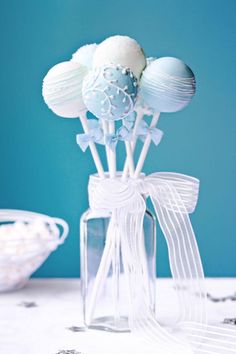 a glass vase filled with white and blue candies