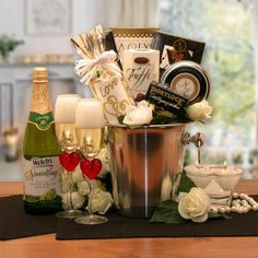 a champagne bucket filled with lots of different types of wine and other items on a table