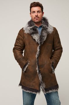 The raw edges of this on-trend design reveal the luxurious Toscana shearling insulation that also lavishes the large collar and trims the placket, cuffs, and sweep. Our Jackson button-front coat showcases distressed Spanish sheepskin, hand pockets with hidden magnet closures and 1 zip pocket inside for invisible storage. Classic Sheepskin Fur Coat For Winter, Shearling Long Fur Coat For Cold Weather, Long Shearling Fur Coat For Cold Weather, Shearling Long Coat For Cold Weather, Classic Sheepskin Coat With Faux Fur Trim, Brown Sheepskin Long Coat, Classic Sheepskin Fur Coat With Faux Fur Trim, Rugged Sheepskin Long Sleeve Outerwear, Rugged Sheepskin Outerwear With Long Sleeves