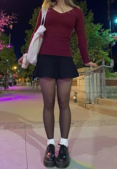 skirt outfit with maroon v neck sweater with platform doc martens and white socks and tote bag in a night city setting Skirt Doc Martens Outfit, 6th Form Outfits, Form Outfits, Martens Outfit, Sixth Form Outfits, Dr Martens Outfit, Doc Martens Outfit, Sixth Form, Downtown Outfits