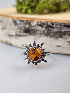 Welcome to handmade Baltic Amber jewelry shop. This Item is made of genuine, natural Amber. This item will make You look simple but gorgeous. Sun shape ring. Brown Baltic amber jewelry. Amber rings. Real gemstone statement ring. Crystal ring. Flaming sun shape small ring. One ring included.  sun size 1.4 cm.   Our handmade jewelry is made with passion and love. If you have any problems with your order please contact us. Please note that colors can vary from originals depending on computer monitor's settings. Due to amber is being unique and natural gemstone, each item may be slightly different in shades or shapes. Items may have natural imperfections like lines and spots, specks, coloration and inclusions, layers and lines .  All amber is fossilized tree resin and it is extremely light gem Minimalist Amber Sterling Silver Jewelry, Minimalist Sterling Silver Amber Jewelry, Nature-inspired Amber Sterling Silver Jewelry, Minimalist Sterling Silver Jewelry With Sun Design, Bohemian Amber Sterling Silver Rings, Unique Amber Jewelry Stamped 925, Unique Round Jewelry With Sun Design, Unique Round Sun Design Jewelry, Handmade Amber Sterling Silver Jewelry