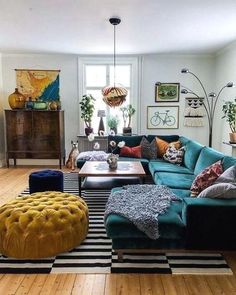 a living room filled with lots of furniture next to a wooden floor covered in rugs