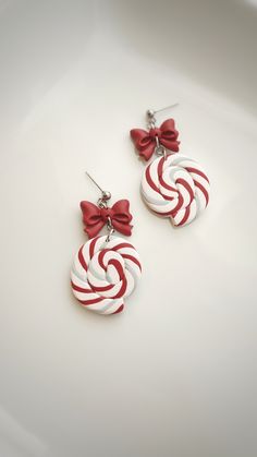 red and white candy cane earrings with bowknots on the earwires