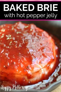 baked brie with hot pepper jelly in a skillet on a wooden counter top