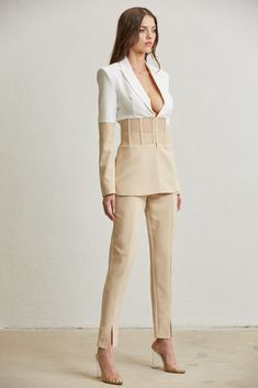 Two-Piece blazer and pant set. Ivory/nude corset blazer with mesh boning. Notched lapel collar. Front hook & eye closure. Padded shoulders. High-waisted tapered pants with front slits. 100% polyester. Lining: 100% polyester. Future Ceo, Corset Blazer, Tapered Pants, Suit Set, Good Stretches, Pant Set, Hook Eye, Lapel Collar, Contrasting Colors