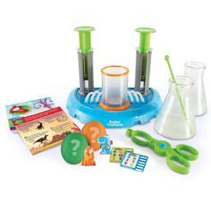 an assortment of toys including beakers, scissors and other items on a white surface