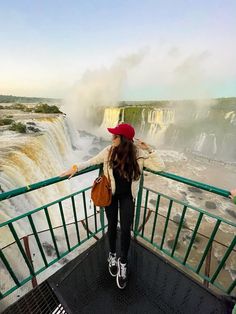 two people are standing on the edge of a viewing platform at niagara falls in niagara, canada