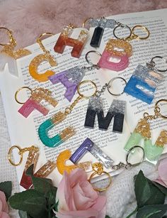 the letters are made out of acrylic and have glitter on them, as well as flowers