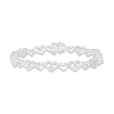 This gorgeous bracelet showcases heart-shaped links crafted in classic sterling silver. A bright round diamond embellishes the center of every other heart for a dazzling touch of sparkle. Eye-catching texturing completes the look. The 7.25-inch bracelet has a total diamond weight of 1/10 carat and secures with a tongue clasp. Gold Layered Bracelets, Pearl Diamond Jewelry, Heart Bracelets, Cross Jewelry Necklace, Fan Jewelry, Diamond Tennis Bracelet, Cross Jewelry, Tennis Bracelet Diamond, Gorgeous Bracelet