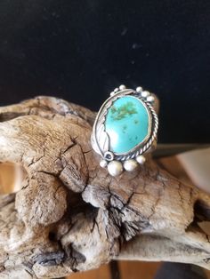 This vintage Men's 925 Native American Massive Turquoise Stone ring is being listed for your selection.  The ring is from the 1970's with a round Sterling Silver bezel and graduated raindrops design. A large Turquoise Cabochon is set onto the Silver Bezel. A 925 feather was added to the twisted frame to help hold the large turquoise cabochon. It is marked "Sterling" on the doubled wide band it's an indication of an older ring. The backside features a flat smooth surface made of Sterling Silver. Upon purchasing I will polish and remove the black markings on the backside. But please let me know if you want it polish as they are many folks who prefer not to have it polished. This ring is in excellent vintage used condition and will arrive with in a ring box with FREE SHIPPING. Size: 8 Turquoi Classic Handmade Turquoise Ring For Anniversary, Southwestern Style Large Turquoise Ring For Anniversary, Antique Turquoise Sterling Silver Ring, Southwestern Style Large Stone Turquoise Ring For Anniversary, Artisan Untreated Turquoise Ring For Anniversary, Vintage Sterling Silver Turquoise Ring With Large Stone, Vintage Sterling Silver Turquoise Ring Stamped 925, Heirloom Style Turquoise Sterling Silver Ring, Untreated Southwestern Turquoise Ring For Anniversary