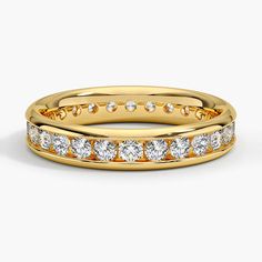 a yellow gold wedding band with diamonds