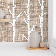 the wallpaper is decorated with white birch trees and cups on wooden shelfs in front of it