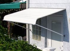 a white awning on the side of a house