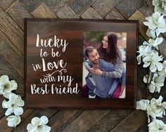 a wooden photo frame with the words lucky to be in love with my best friend