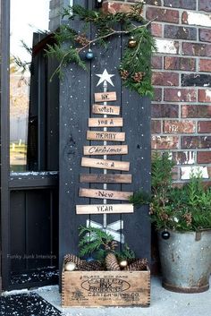 a christmas tree made out of wooden planks on the front door of a house