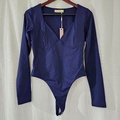 a blue bodysuit is hanging on a hanger