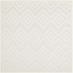 a white rug with an abstract design on the bottom, and a diamond pattern in the middle