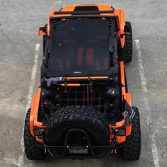 an orange vehicle parked in a parking lot