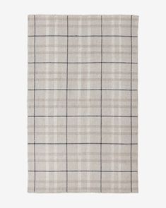 a beige and black plaid rug on a white background