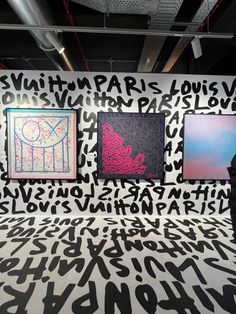 an art gallery with black and white letters on the wall