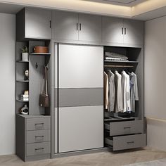 an open closet with drawers and clothes hanging on the wall