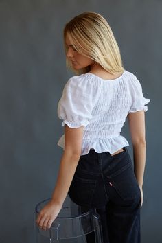 Day or night, you can't go wrong with the Melissa Puff Sleeve Crop Top! This feminine top features a v neckline, smocked bodice, puff sleeves, and a ruffle hem. Pair with Levi's Ribcage Wide Leg Jeans in Rosie Posie to compete the look! Details 100% Cotton Slip on Elastic band on sleeves Hand wash cold / Line dry Spring V-neck Puff Sleeve Top With Ruffles, Spring V-neck Smocked Top With Gathered Sleeves, Fitted V-neck Tops With Ruffle Hem, Fitted V-neck Blouse With Smocked Cuffs, Fitted Smock V-neck Top, Billowy Smocked Top With Ruffles, Chic V-neck Smocked Top With Ruffles, Feminine Fitted Puff Sleeve Top With Ruffle Hem, Casual V-neck Peasant Top With Smocked Bodice