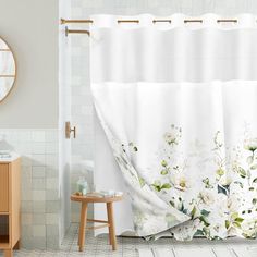 a white shower curtain with flowers on it