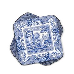 three blue and white plates with an image of people in the park on one plate