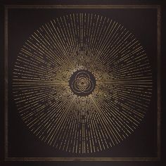 a black and gold framed artwork with an intricate design in the center, on a dark background