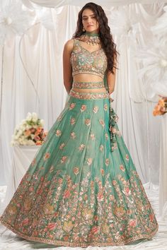 Look elegant when wearing this seafoam green organza lehenga which features beautiful embroidery work.This sweetheart neckline and sleeveless blouse is highlighted with resham thread, sequins, stone, zari, patch, and dori work.Paired with organza panelled style lehenga in seafoam green color with seafoam green net dupatta.Panelled style lehenga has resham thread, sequins, stone, zari, patch, and dori work.Dupatta elaborated using resham thread, sequins, stone, zari, and dori work.This lehenga blouse can be customized up to the maximum size available in inches 58. Slight color variation may occur due to photographic reasons. Diwali Fashion, Lime Green Weddings, Embroidery Lehenga, Gold Lehenga, Organza Lehenga, Lehenga Fabric, Stitched Lehenga, Purple Saree, Bollywood Dress