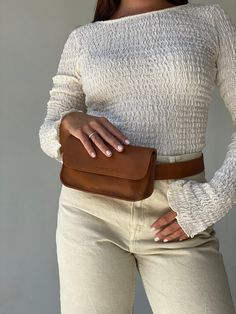 "Check out other products from our shop below:  https://www.etsy.com/shop/MandrnStudio The Ziggy zags across the intersection of timeless elegance and practical versatility with all of its wearable options, making you look effortlessly chic. Wear it 4 ways as a fanny pack, crossbody, clutch, and a stand-alone belt.  PRODUCT FEATURES: 100% premium cowhide leather locally sourced in Indonesia Handmade with love by our artisan friends in Bali Wear it 4 ways as a belt, crossbody, fanny pack and clutch Removable leather wristlet so you can wear your Ziggy like a clutch Belt strap that doubles as an everyday belt to wear Cotton linen lining in a taupe tone Large enough to carry an iPhone 13 Pro Max, cardholder wallet, make-up, and other essentials Inside zipper pocket  Bag dimensions: 7.5\" x 4\ Crossbody Fanny Pack, Bum Bags, Tan Leather Belt, Dark Outfits, Leather Fanny Pack, Leather Belt Bag, Crossbody Clutch, Leather Conditioner, Bag Handmade