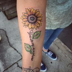 a sunflower tattoo on the arm that says, you are my sunshine