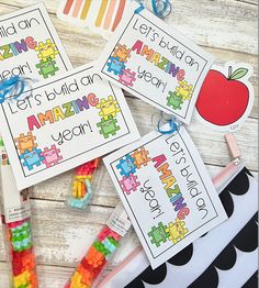 some colorful pieces of paper with words on them and an apple in the middle next to them