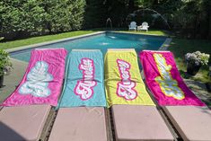 towels laid out in front of a swimming pool