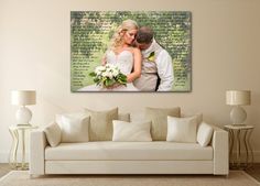 a bride and groom kissing in front of a wall with the words love written on it