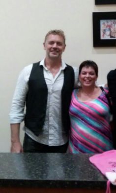 two men and a woman standing in front of a counter