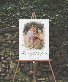 an easel stands in front of a stone wall