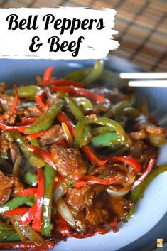 beef and peppers stir fry on a plate with chopsticks